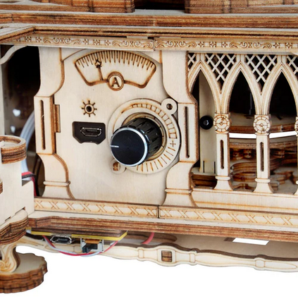 Close-up of a wooden gramaphone with intricate design and components.