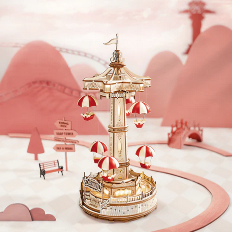 Decorative model of a carousel with hot air balloons in a stylized setting