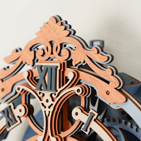 Close-up of a decorative clock mechanism with intricate details on a white background